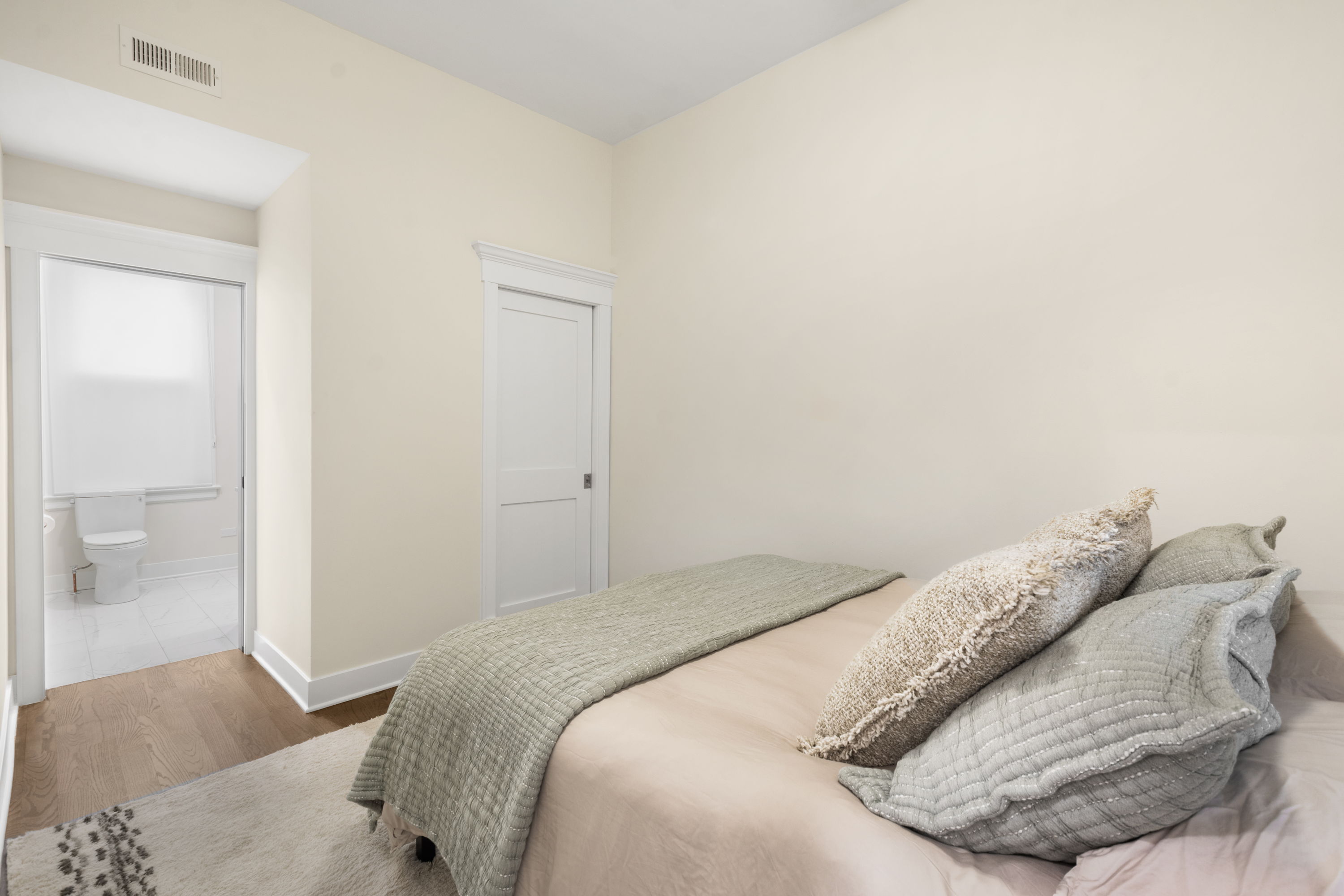 Bedroom 2 with a view into its ensuite bathroom