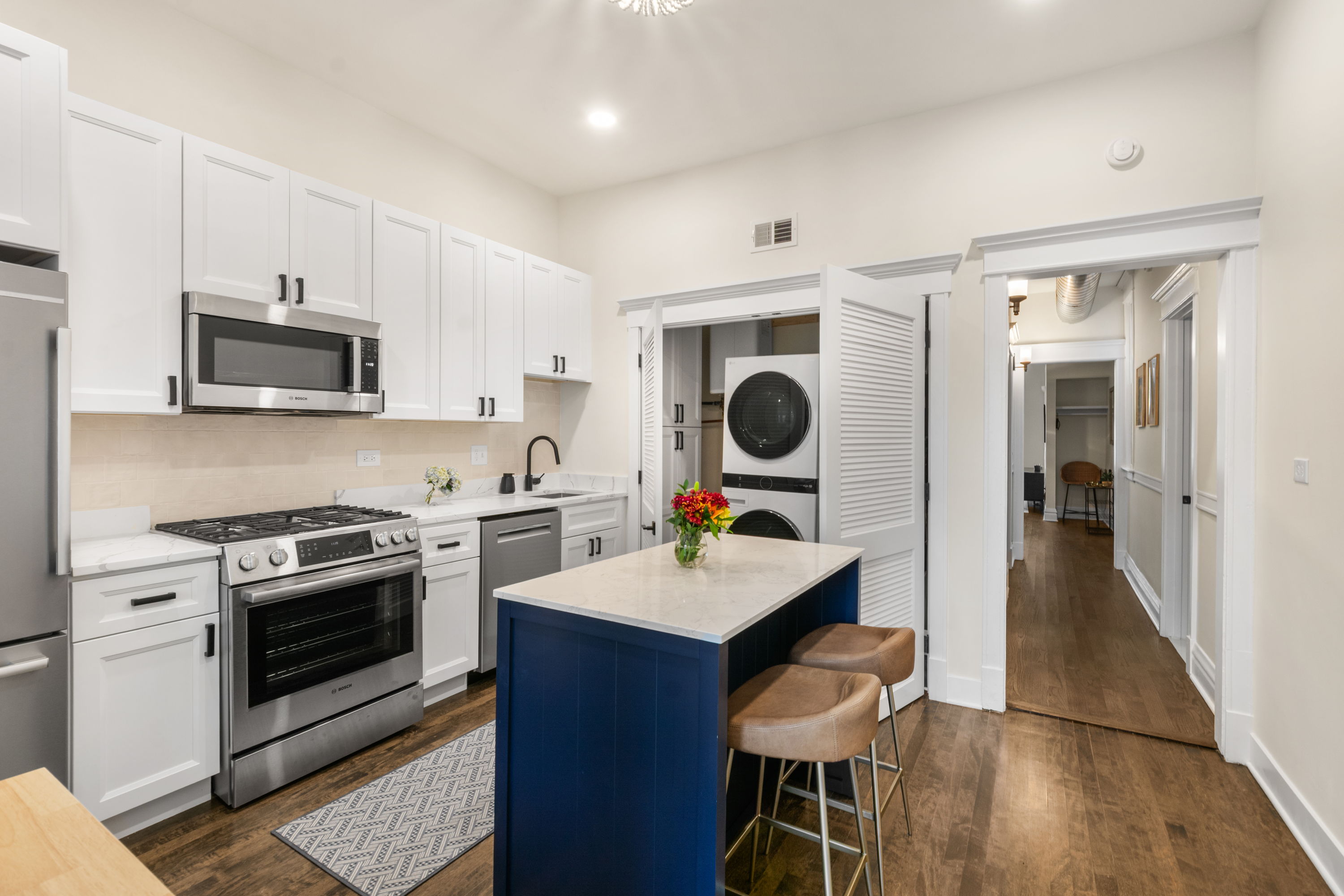 Second view of the kitchen showing gas range and hardwood floors